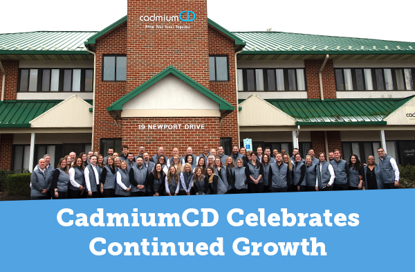 CadmiumCD team celebrating their continued growth in front of the building they now occupy in Forest Hill Maryland