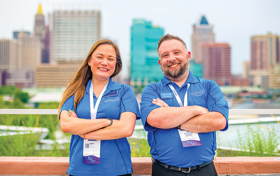 CadmiumCD employees standing back to back upon the Baltimore skyline