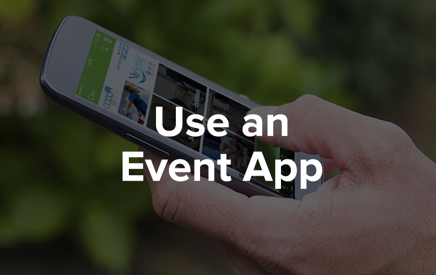Someone holds an iPhone with an event app on the screen in their hand. They are outside in a sunny, green environment. That conference must have been really great because they're still interacting with the content and connecting with people through the app even after the meeting is over.