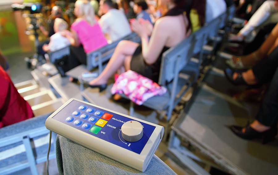 An old school clicker audience response system. There is no social aspect to this. It's Pavlovian.