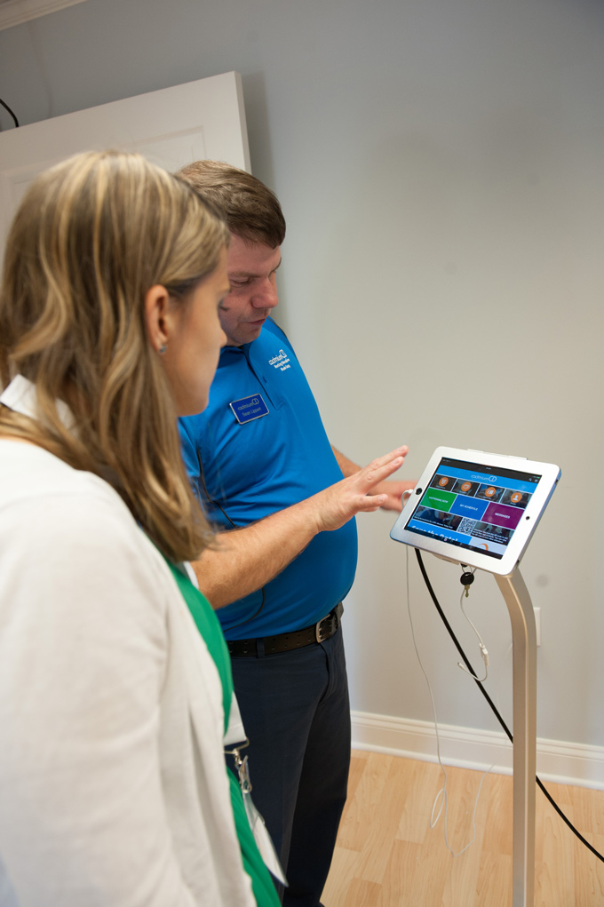 CadmiumCD developer Sean Lippert explaining eventScribe 2.0, a modern event app for meeting planners, conference organizers, and education directors, to a CadCon attendee and CadmiumCD software user.