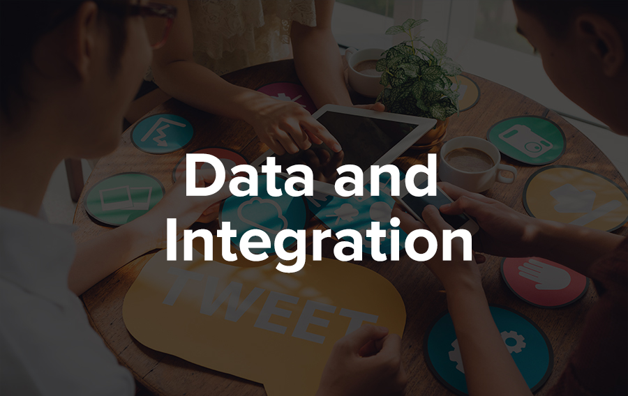 Three meeting planners play with their event app around a table to make sure their data is correctly integrating across their Association Management System (AMS), their Customer Relationship Management Software (CRM), their event management platform, their registration tools, and their social media.