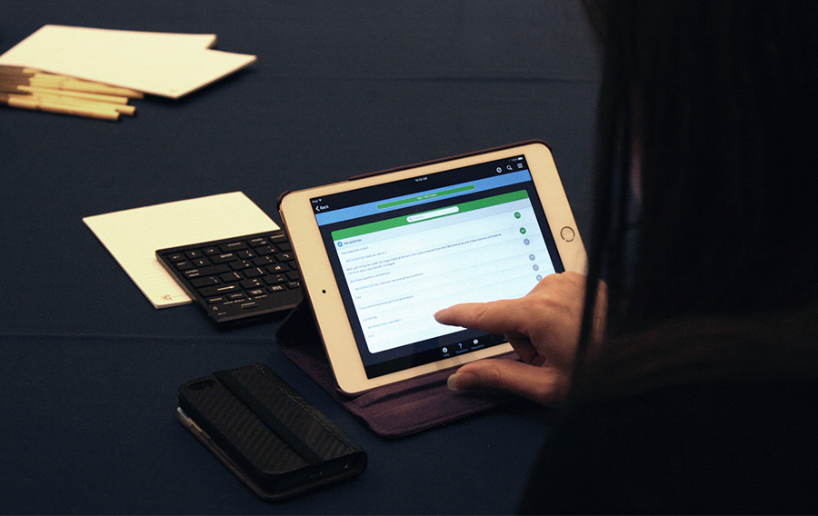 An attendee upvotes quetions that other attendees ask on her iPad. This ensures the most relevant questions will get answered by speakers first.